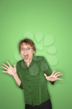 Royalty Free Photo of a Smiling Woman Gesturing on a Green Background