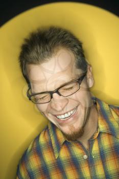 Royalty Free Photo of a Vignette of a Man on Yellow Background Laughing