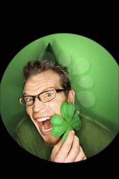 Royalty Free Photo of a Vignette of a Man Wearing a Saint Patrick's Day Hat and Holding a Shamrock