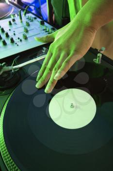 Royalty Free Photo of a DJ's Hand Spinning a Vinyl Record