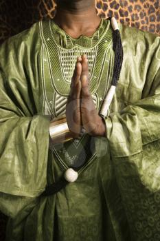 Royalty Free Photo of an African-American Man Wearing Traditional African Clothing in Prayer
