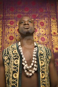Royalty Free Photo of an African-American Man Wearing an Embroidered African Vest and Beads