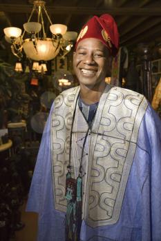 Royalty Free Photo of a Smiling African American Man Wearing Traditional African Clothing
