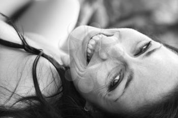 Royalty Free Photo of a Woman Lying on Her Back Smiling