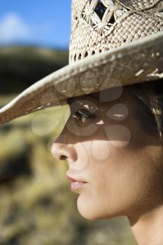 Royalty Free Photo of a Woman Wearing a Straw Cowboy Hat