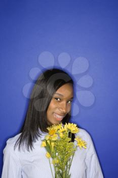 Royalty Free Photo of a Teen Girl Holding a Bouquet of Flowers