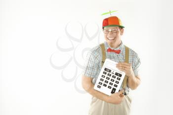 Royalty Free Photo of a Nerdy Man Wearing a Propeller Cap Holding a Large Calculator