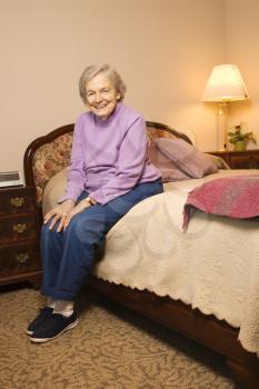 Elderly woman in her bedroom at retirement community center.