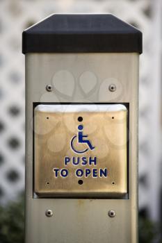 Metal door entrance button for physically challenged or handicapped people.