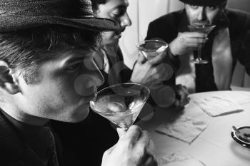 Royalty Free Photo of Three Men Drinking Martinis 