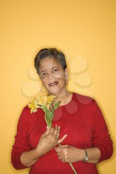 Royalty Free Photo of an Older Female Holding Flowers