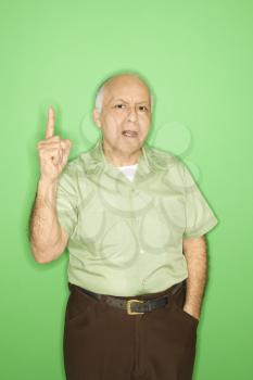 Royalty Free Photo of an Older Man Holding His Finger Up