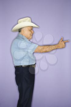 Royalty Free Photo of an Older Man Wearing a Cowboy Hat