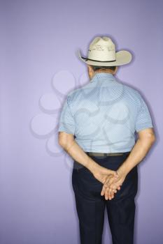 Royalty Free Photo of an Older Male Wearing a Cowboy Hat