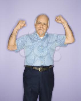 Royalty Free Photo of an Older Man Flexing Muscles