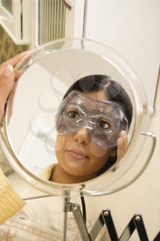 Royalty Free Photo of a Close-up Mirror Reflection of a Young Woman Wearing an Eye Mask