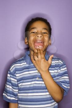 Royalty Free Photo of a Young Boy Showing Where His Tooth Fell Out