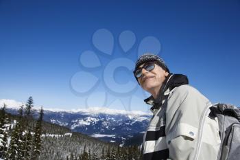 Royalty Free Photo of a Senior Male Skier Posing on a Mountain