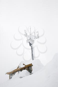 Royalty Free Photo of Cabin and Antenna Covered in Snow