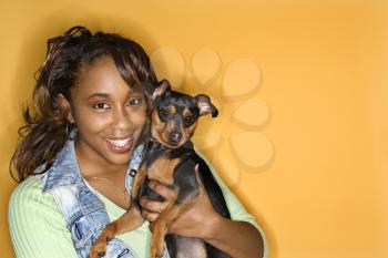 Royalty Free Photo of a Woman Holding Miniature Pinscher Dog