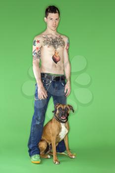 Royalty Free Photo of a Young Male With a Boxer Dog
