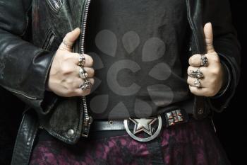Royalty Free Photo of a Woman's Hands With Silver Rings Holding Onto a Black Leather Jacket