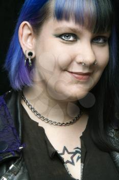 Head shot of Caucasian woman with blue hair.