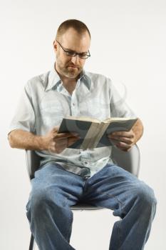 Royalty Free Photo of a Man Sitting Reading a Book