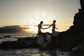 Royalty Free Photo of a Couple on a Beach at Sunset