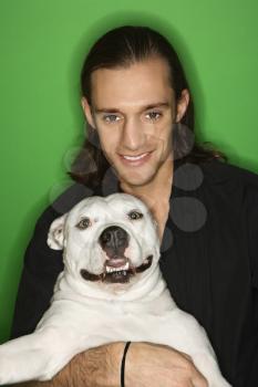 Royalty Free Photo of a Man Holding a White Pit Bull