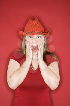 Royalty Free Photo of a Woman Wearing a Red Cowboy Hat
