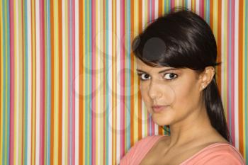 Royalty Free Photo of a Young Woman Standing in Front of a Striped Background