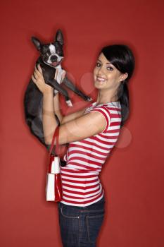 Royalty Free Photo of a a Woman Holding a Boston Terrier Dog