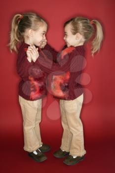 Royalty Free Photo of Twin Girls Dancing Together