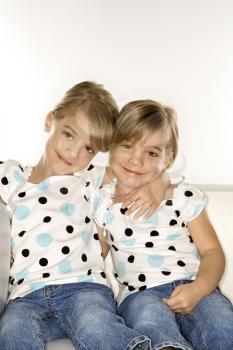 Royalty Free Photo of Twin Girls Sitting Together 