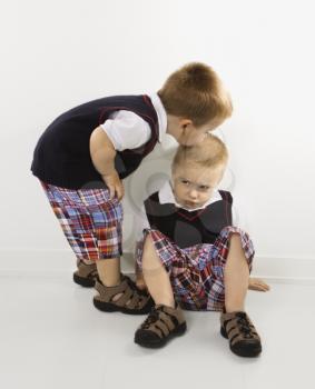 Royalty Free Photo of a Twin Boy Kissing His Brother on the Head
