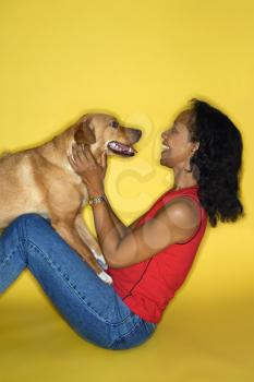 Royalty Free Photo of a Female Petting a Dog