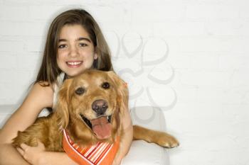 Royalty Free Photo of a Girl Holding a Golden Retriever Dog