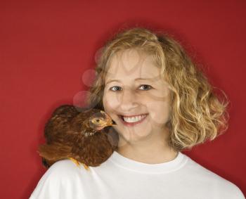 Royalty Free Photo of a Woman With a Chicken on Her Shoulder