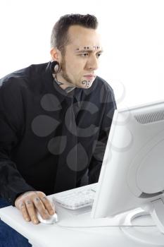 Royalty Free Photo of a Tattooed Man Using a Computer