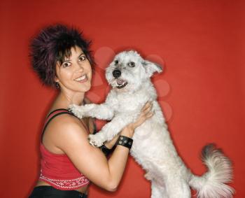 Royalty Free Photo of a Woman Holding a Small White Dog