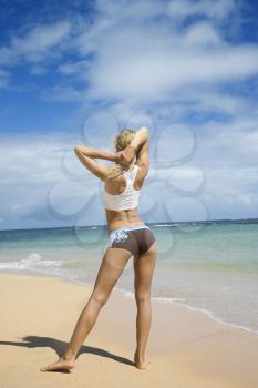 Royalty Free Photo of a Woman Stretching on a Beach