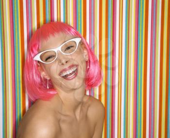 Royalty Free Photo of a Woman in a Pink Wig Smiling