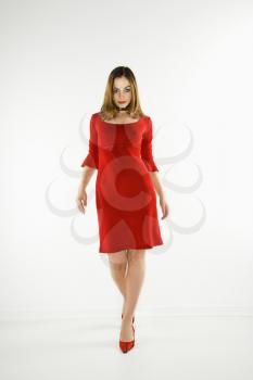 Royalty Free Photo of a Woman Wearing a Red Dress Walking