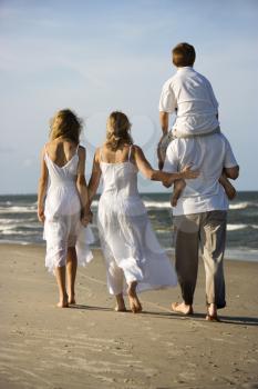 Royalty Free Photo of a Family Walking on a Beach
