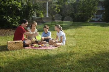 Royalty Free Photo of a Family Picnicking in the Park