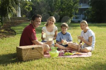 Royalty Free Photo of a Family Picnicking in the Park