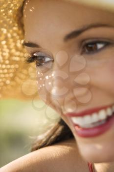 Royalty Free Photo of a Close-up of a Woman Wearing a Straw Hat