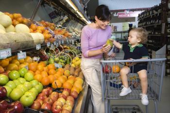 Royalty Free Photo of a Mother Grocery Shopping With Her Toddler Son