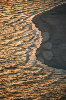 Aerial view of sun over Atlantic ocean and shoreline of Bald Head Island, North Carolina.